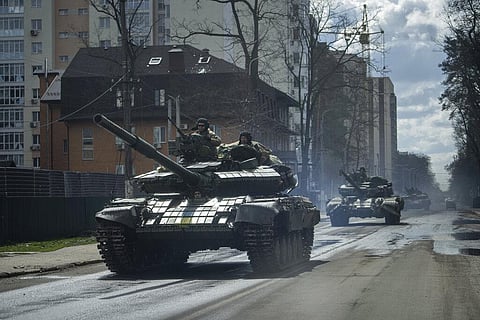 Ukrainian tanks move in a street in Irpin, in the outskirts of Kyiv. (File Photo | AP)