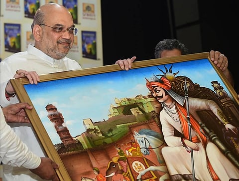 Union Home Minister Amit Shah receives a memento during the launch of a book 'Maharaja: Sahastra Varshon Ka Dharmyudh' in New Delhi. (Photo | PTI)