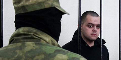 British citizen Aiden Aslin stands behind bars in a courtroom in Donetsk, eastern Ukraine on Thursday, June 9, 2022. (Photo |AP)