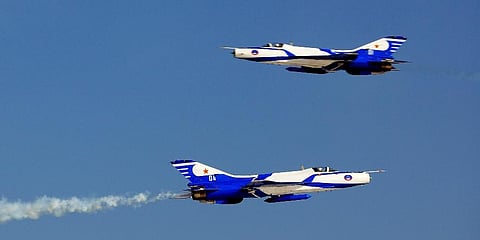 Two J-7 fighters perform in an aerobatic show to celebrate the 60th anniversary of the People's Liberation Army Air Force in Beijing on Nov. 11, 2009. (Photo | AP)