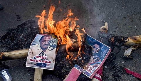 Posters of now-suspended BJP leaders Nupur Sharma and Naveen Jindal set on fire during a protest over the controversial remarks of the two leaders. (Photo | PTI)