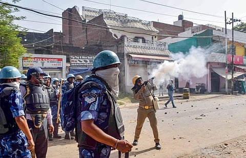 Security personnel use tear gas to disperse protestors during a protest over controversial remarks made by two now-suspended BJP leaders about Prophet Mohammad, in Prayagraj. (Photo | PTI)