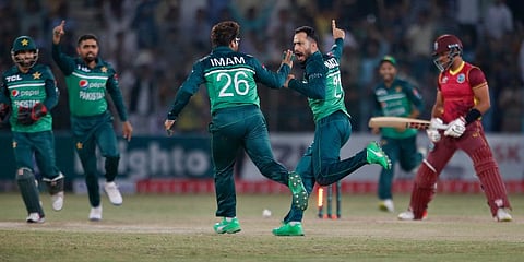 Pakistan's Mohammad Nawaz (C) and teammates celebrate after the dismissal of West Indies' Brandon King (R) during the second ODI at the Multan Cricket Stadium. (Photo | AP)