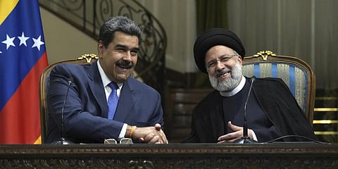 Iranian President and his Venezuelan counterpartshake hands at the conclusion of their joint news briefing at the Saadabad Palace in Tehran, Iran, June 11, 2022. (Photo |AP)