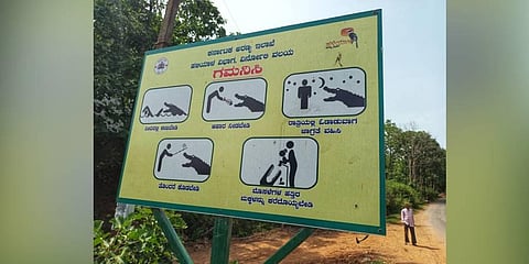 A caution board that has come up along Kali River in Dandeli (Photo | Express)