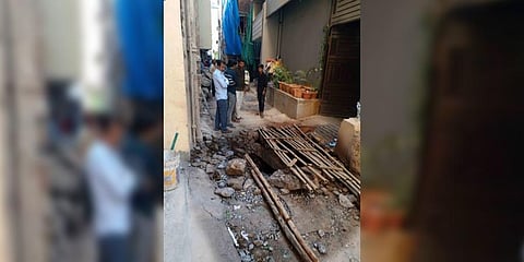 Locals gather at the spot where the explosion took place at Gowliguda in Hyderabad on Sunday morning.