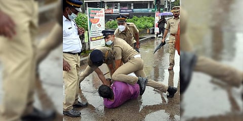 An activist being beaten up by the police during a protest by Yuva Morcha in Kozhikode demanding the resignation of Chief Minister Pinarayi Vijayan.(Photo | E Gokul )
