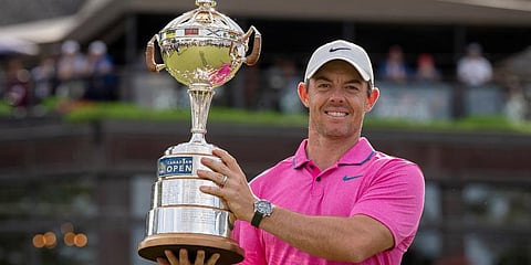 Rory McIlroy, of Northern Ireland, hoists the trophy after winning the Canadian Open golf tournament in Toronto. (Photo | AP)