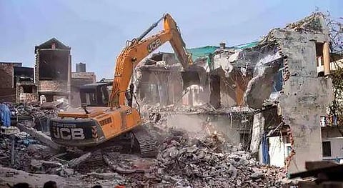 Bulldozer being used to demolish the 'illegally constructed' residence of accused Javed Ahmed in Prayagraj on Sunday. (Photo | PTI)