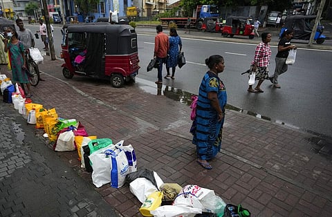 People place their canisters in line as they wait to buy kerosene oil outside a fuel station in Colombo, Sri Lanka, Saturday, June 11, 2022(Photo | AP)