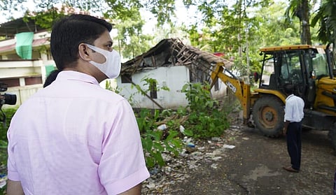 Collector Jafar Malik at the site to assess demolition of buildings as part of NH-66 widening at Moothakunnam. (Photo | Express)