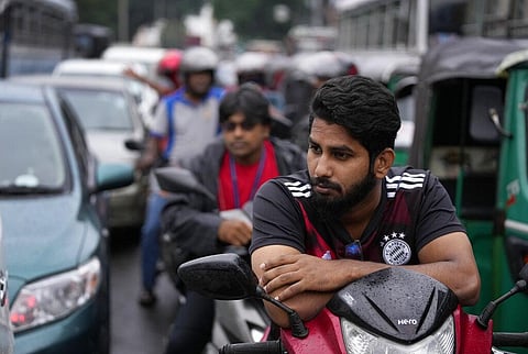 People wait in a long queues to buy fuel for their vehicles at a filling station in Colombo, Sri Lanka, Saturday, June 11, 2022. (Photo | AP)