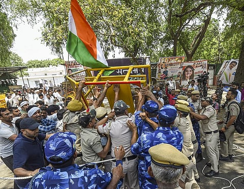 Police stop Congress workers who were staging a protest outside the AICC office in New Delhi, Wednesday. (Photo | PTI)