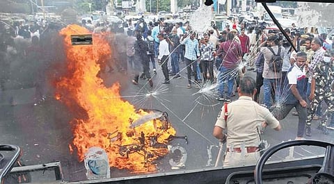 Congress workers burn a scooter and damage the windshield of a TSRTC bus during the Chalo Raj Bhavan rally in Hyderabad on Thursday | R V K Rao