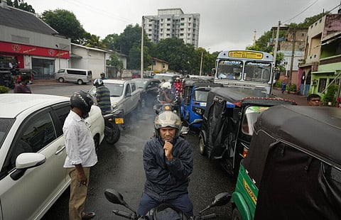People wait in a long queues to buy fuel for their vehicles at a filling station in Colombo, Sri Lanka, Saturday, June 11, 2022. (Photo | AP)