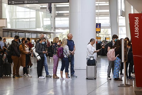 People stream beyond the queue line at a security checkpoint into the International Terminal at San Francisco International Airport. (Photo| AP)