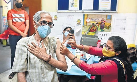 A heath worker administers the vaccine against Covid-19 to a senior citizen. (Photo | Express)