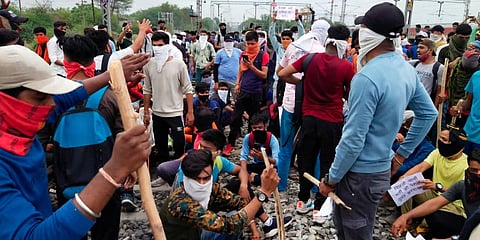 Young people block a railway line while protesting against Centre's 'Agnipath' scheme, in Indore. (Photo | PTI)
