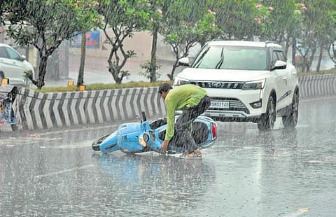 A rider skids on a slippery road in the rains in Vijayawada. (Photo| Prasant Madugula, EPS)