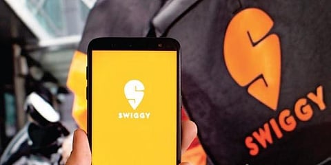 The logo of food delivery app Swiggy is seen on the phone. (Photo | File)