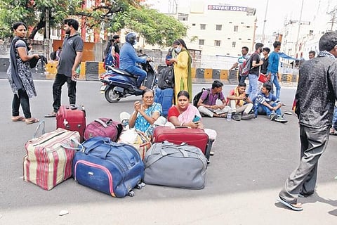 People squat on the road outside the station, unable to find any transport | R V K RAO