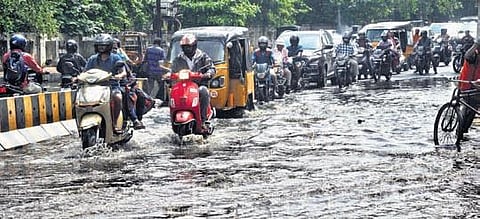 Drainage water flowing on a road in Visakhapatnam on Saturday. (Photo | G Satyanarayana)