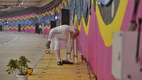 PM Modi picks up litter at newly-inaugurated tunnel in New Delhi on Sunday. (Photo | ANI Twitter)