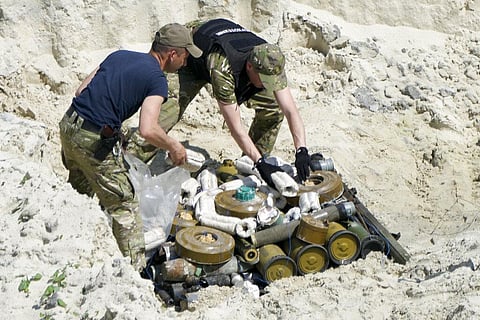 Ukrainian servicemen prepare to detonate unexploded Russian ammunition in the outskirts of Kyiv, Ukraine, Wednesday, June 1, 2022.(Photo | AP)