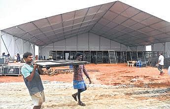 Workers erect a stage at Kommaghatta