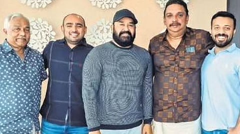 Shibu Baby John poses for a photo with actor Mohanlal and director Vivek after the logo launch of John & Mary Creative in Kochi 