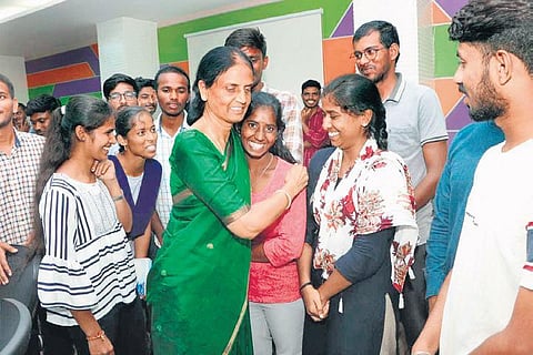 Education Minister P Sabitha Indra Reddy hugs a student during her visit to  IIIT-Basara after the strike was called off, on Tuesday
