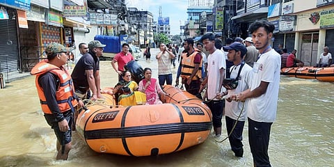District administration rescue a nine-month pregnant woman amid the flood situation, in Cachar. (Photo| PTI)