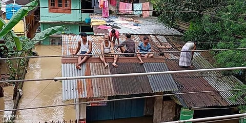 As flood water submerged houses, residents climbed onto their rooftops to escape.(Photo | Special arrangement)