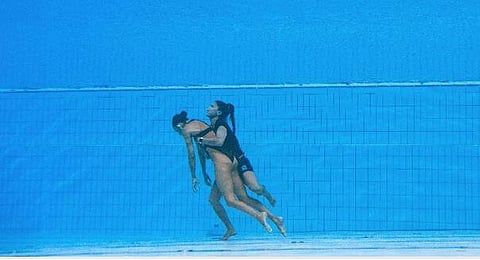 Team USA coach Andrea Fuentes (right) rescues unconscious artistic swimmer Anita Alvarez from the bottom of the pool during the Aquatic World Championships in Budapest. (Photo | AFP Twitter)