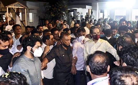 Maharashtra CM Uddhav Thackeray greets supporters gathered outside his private residence 'Matoshree', after leaving from his official residence 'Varsha', in Mumbai. (Photo | PTI)