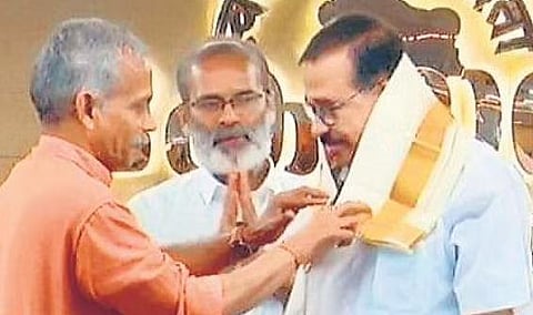 RSS leader J Nandakumar felicitating  KNA Khader at a function in Kozhikode on Tuesday