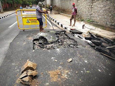 A portion of the newly-relaid Mariyappanapalya Jnana Bharthi main road in Bangalore University campus caved in. (Photo | EPS)