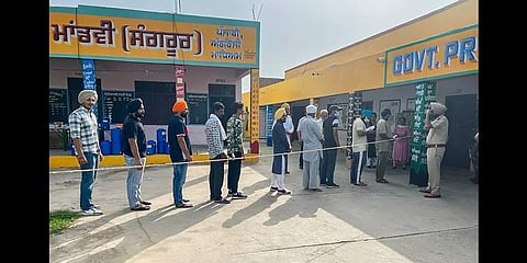 People queue up at a polling station to cast their votes for the Sangrur Lok Sabha bypolls, in Sangrur(Photo | PTI)