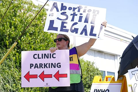 Clinic escort Kim Gibson stands outside the Jackson Women's Health Organization clinic calling out to incoming patients that the clinic is still open. (Photo | AP)