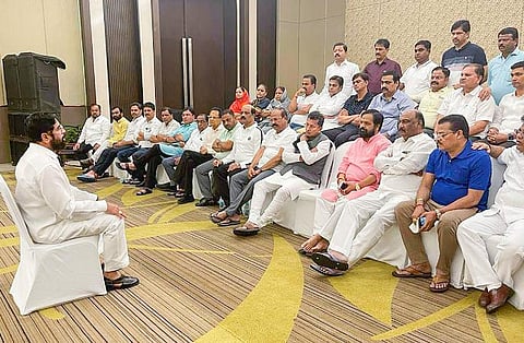 Rebel Shiv Sena leader Eknath Shinde interacts with MLAs at a hotel in Guwahati, Assam, on June 23, 2022. (Photo | PTI)