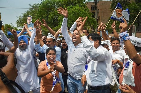 AAP workers celebrate after the party candidate Durgesh Pathak's lead during the counting of votes of Rajinder Nagar by-elections, in New Delhi. (Photo | PTI)
