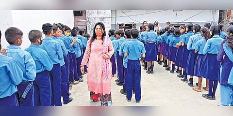 Namrata Anand with women at a pottery training centre in Patna and 9top) with children at her school