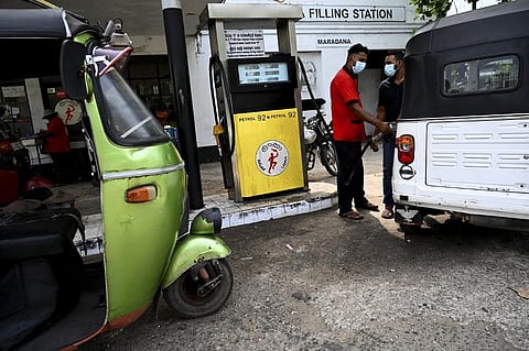 A worker fills the tank of an auto rickshaw at a petrol station in Colombo. (File Photo | AFP)