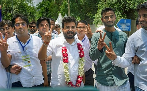 AAP candidate Durgesh Pathak flashes victory sign after winning Rajinder Nagar by-elections, in New Delhi. (Photo | PTI)