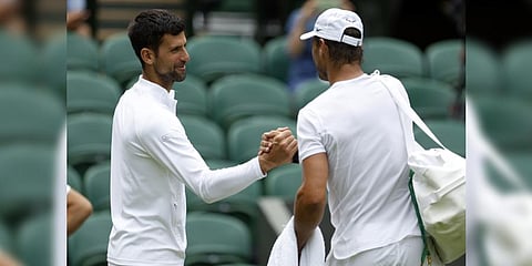 Spain's Rafael Nadal, right, greets Serbia's Novak Djokovic during a practice session on on Center Court ahead of the 2022 Wimbledon Championship.(Photo | AP)