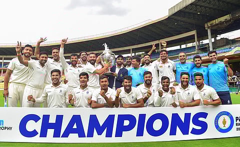 The victorious Madhya Pradesh team wih the support staff at the M Chinnaswamy Stadium in Bengaluru on Sunday. They defeated Mumbai by six wickets(Photo | PTI)
