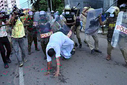 A UDF activist falls on the road as the police resort to caning during a protest march held in Kottayam. (Photo | Vishnu Prathap)
