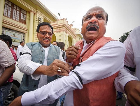 Congress legislators tie black ribbon on their arms to protest against the Agnipath scheme,during the ongoing Monsoon session of the Assembly, in Patna. (Photo | PTI)