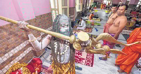 A sadhu holds a trident at the Ram Mandir base camp of Amarnath Yatra in Jammu on Monday | PTI