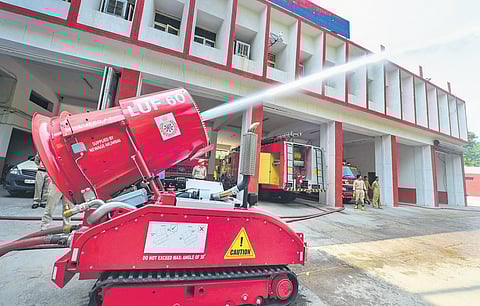 A robot demonstrates firefighting at Lakshmi Nagar Fire Station on Monday (Photo | PTI)